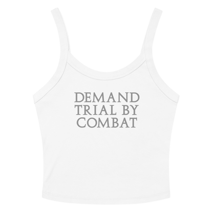 "Demand trial by combat" printed on a solid white blend women's micro-rib tanktop laying on a flat surface amongst sunglasses and shorts