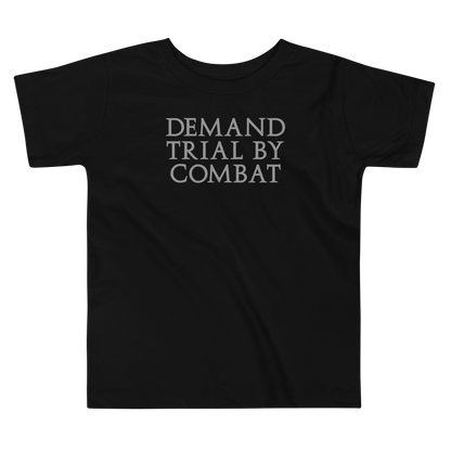 "Demand trial by combat" printed on a black toddler short sleeve tee laying on a flat surface