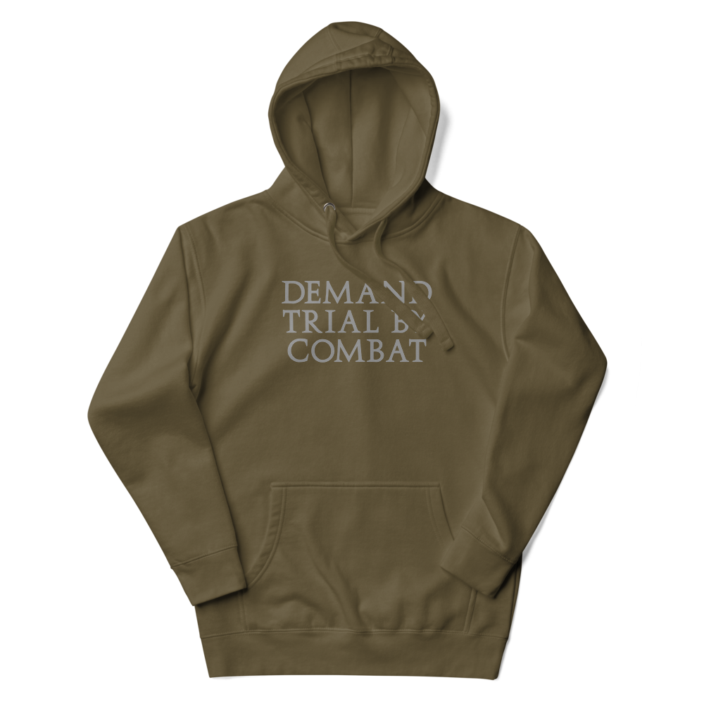 "Demand trial by combat" printed on a military green unisex hoodie laying on a flat surface with the hood up