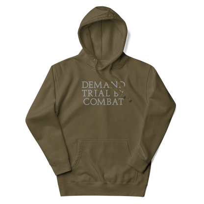 "Demand trial by combat" printed on a military green unisex hoodie laying on a flat surface with the hood up