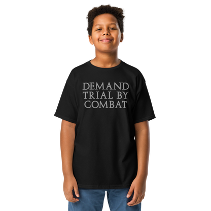 "Demand trial by combat" printed on a black youth classic tee worn by a male