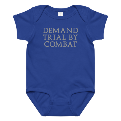 "Demand trial by combat" printed on a royal baby jersey bodysuit laying on a flat surface amongst other clothes