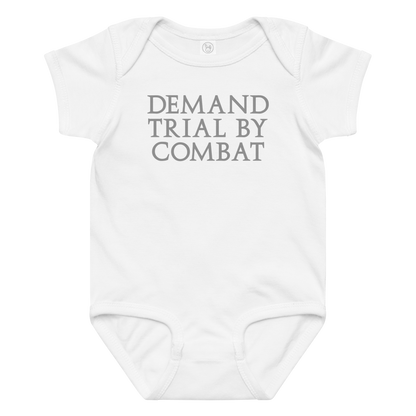 "Demand trial by combat" printed on a white baby jersey bodysuit laying on a flat surface amongst other clothes