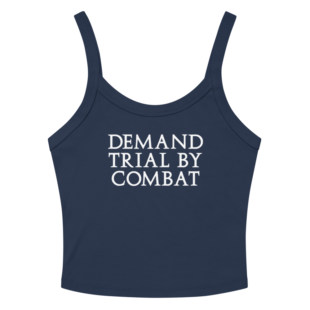 "Demand trial by combat" printed on a solid navy blend women's micro-rib tanktop laying on a flat surface amongst sunglasses and shorts