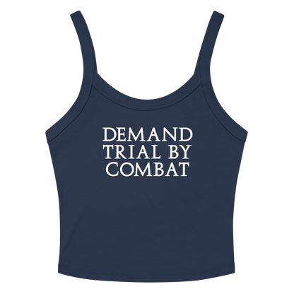 "Demand trial by combat" printed on a solid navy blend women's micro-rib tanktop laying on a flat surface amongst sunglasses and shorts