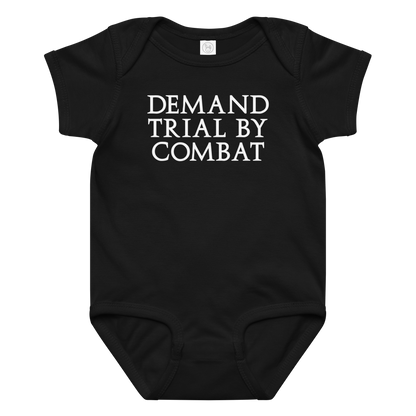 "Demand trial by combat" printed on a black baby jersey bodysuit laying on a flat surface amongst other clothes