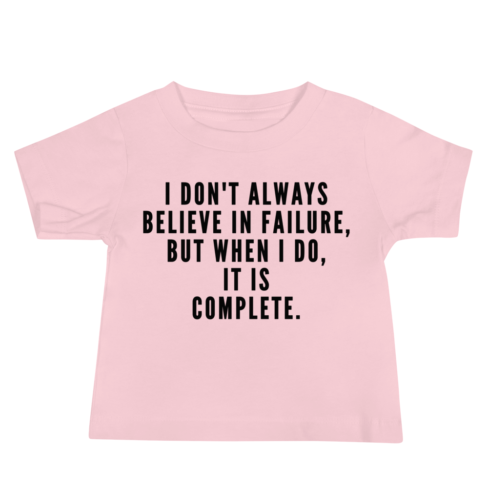 "I don't always believe in failure, but when I do, it is complete." printed on a pink baby jersey short sleeve tee laying on a flat surface