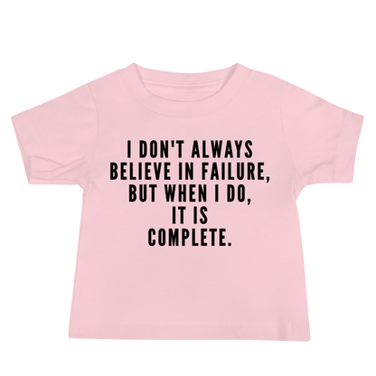 "I don't always believe in failure, but when I do, it is complete." printed on a pink baby jersey short sleeve tee laying on a flat surface