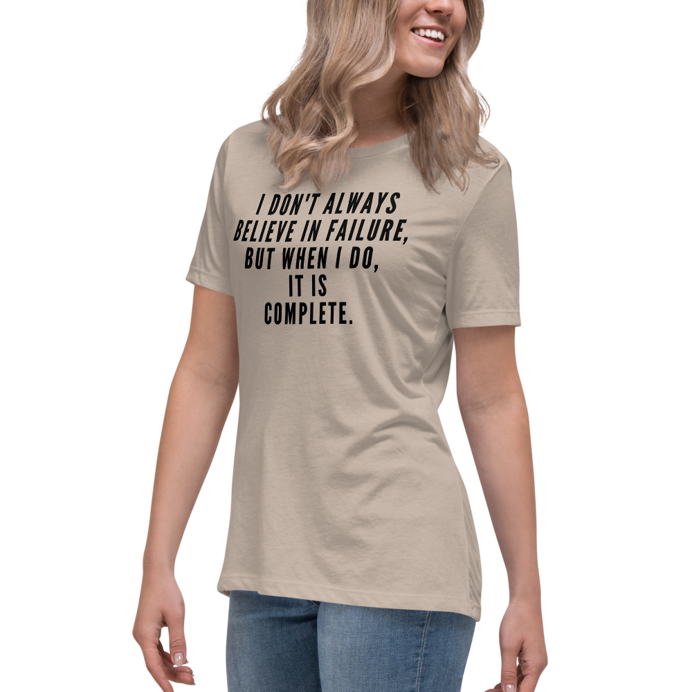 "I don't always believe in failure, but when I do, it is complete." printed on a heather stone women's relaxed t-shirt worn by a female