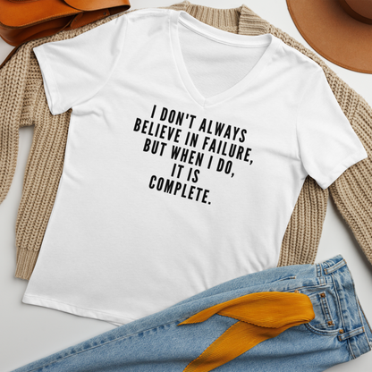 "I don't always believe in failure, but when I do, it is complete." printed on a solid white blend women's relaxed v-neck t-shirt laying on a flat surface amongst other clothes