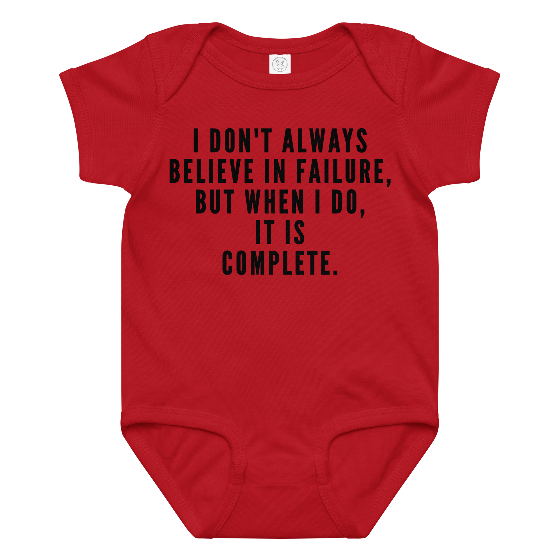 "I don't always believe in failure, but when I do, it is complete." printed on a red baby jersey bodysuit laying on a flat surface amongst other clothes