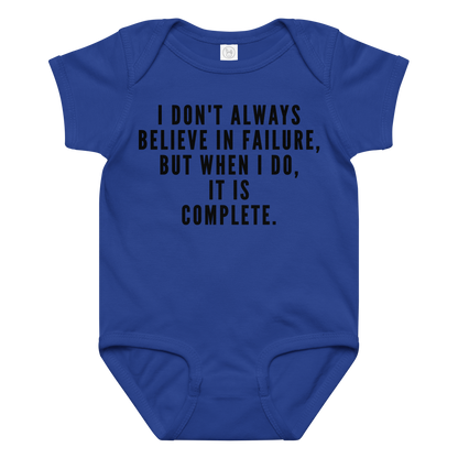 "I don't always believe in failure, but when I do, it is complete." printed on a royal baby jersey bodysuit laying on a flat surface amongst other clothes