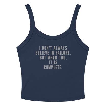 "I don't always believe in failure, but when I do, it is complete." printed on a solid navy blend women's micro-rib tanktop laying on a flat surface amongst sunglasses and shorts