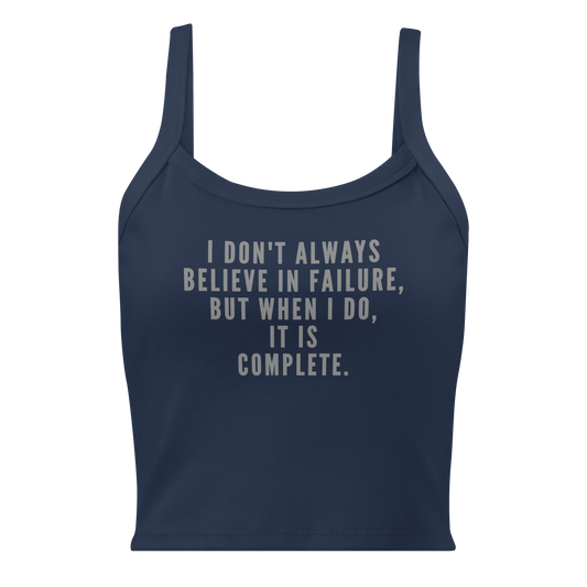 "I don't always believe in failure, but when I do, it is complete." printed on a solid navy blend women's micro-rib tanktop laying on a flat surface