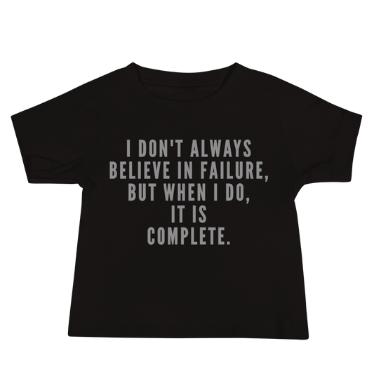 "I don't always believe in failure, but when I do, it is complete." printed on a black baby jersey short sleeve tee laying on a flat surface