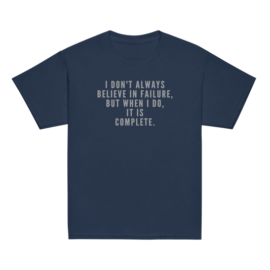 "I don't always believe in failure, but when I do, it is complete." printed on a navy youth classic tee laying on a flat surface