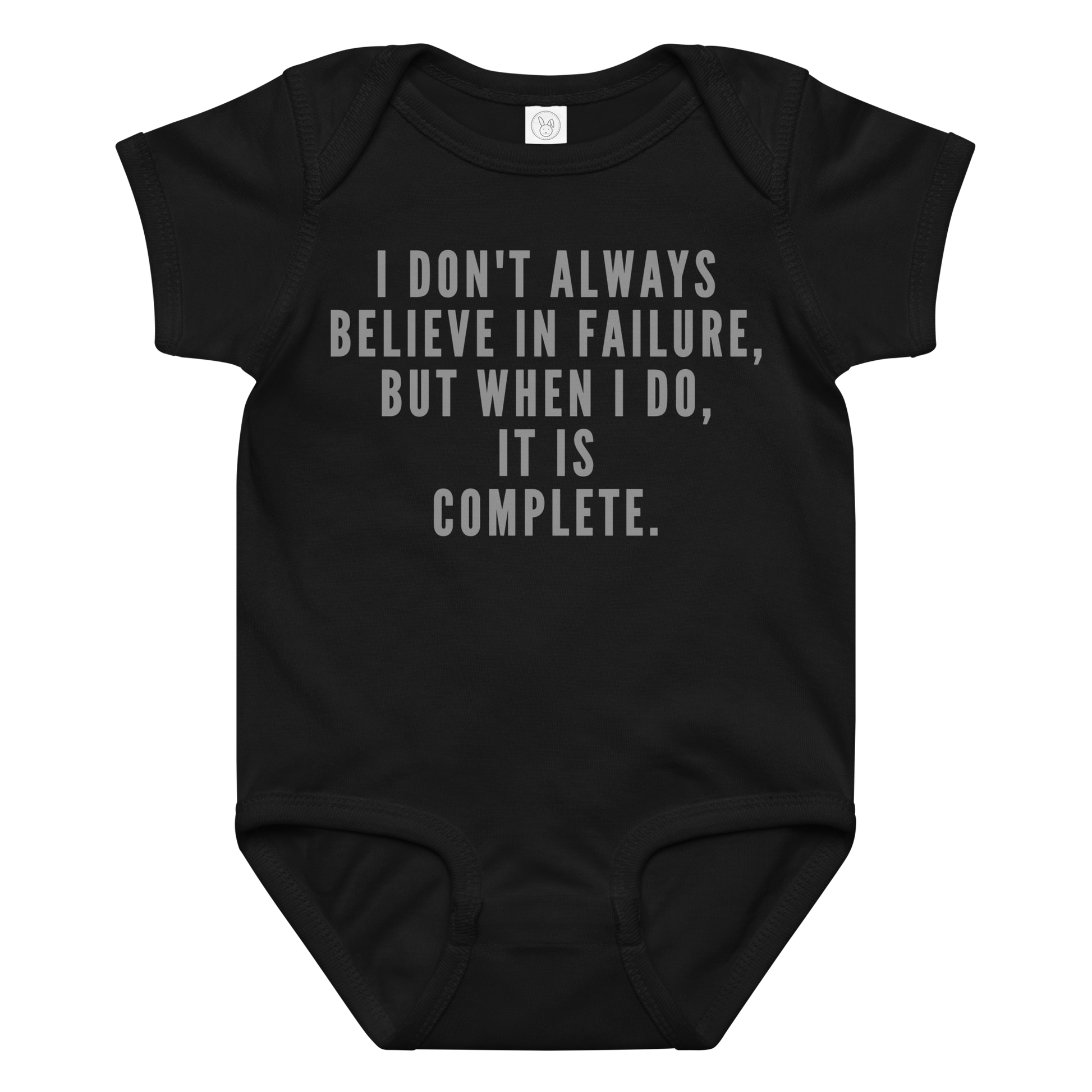 "I don't always believe in failure, but when I do, it is complete." printed on a black baby jersey bodysuit laying on a flat surface amongst other clothes