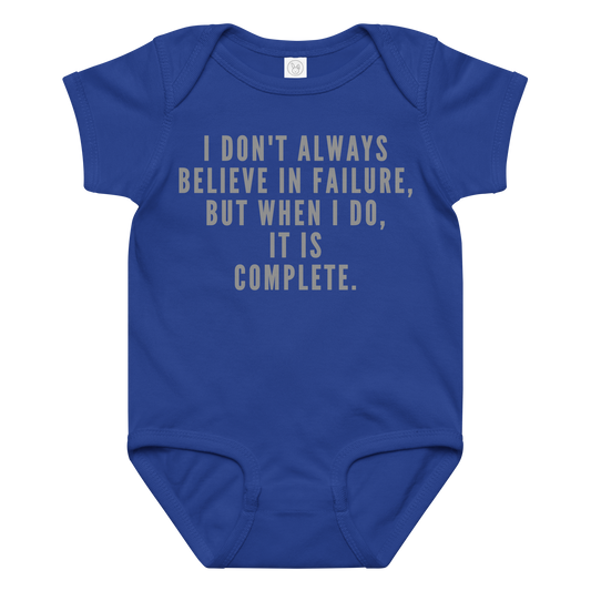 "I don't always believe in failure, but when I do, it is complete." printed on a royal baby jersey bodysuit laying on a flat surface amongst other clothes