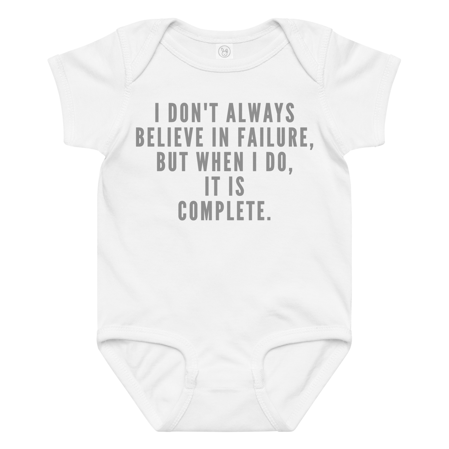 "I don't always believe in failure, but when I do, it is complete." printed on a white baby jersey bodysuit laying on a flat surface amongst other clothes