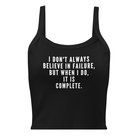 "I don't always believe in failure, but when I do, it is complete." printed on a solid black blend women's micro-rib tanktop laying on a flat surface