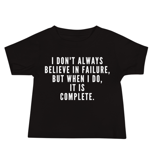 "I don't always believe in failure, but when I do, it is complete." printed on a black baby jersey short sleeve tee laying on a flat surface