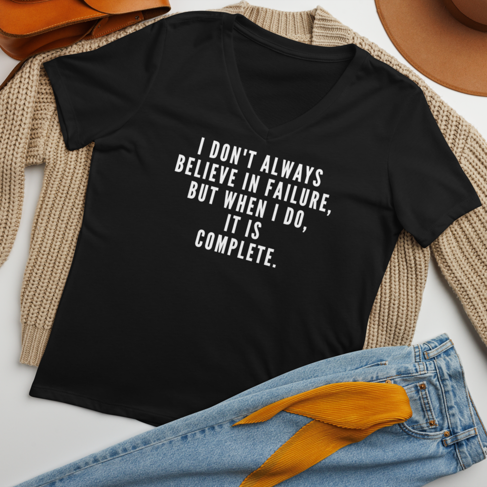 "I don't always believe in failure, but when I do, it is complete." printed on a solid black blend women's relaxed v-neck t-shirt laying on a flat surface amongst other clothes