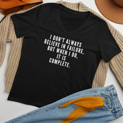 "I don't always believe in failure, but when I do, it is complete." printed on a solid black blend women's relaxed v-neck t-shirt laying on a flat surface amongst other clothes
