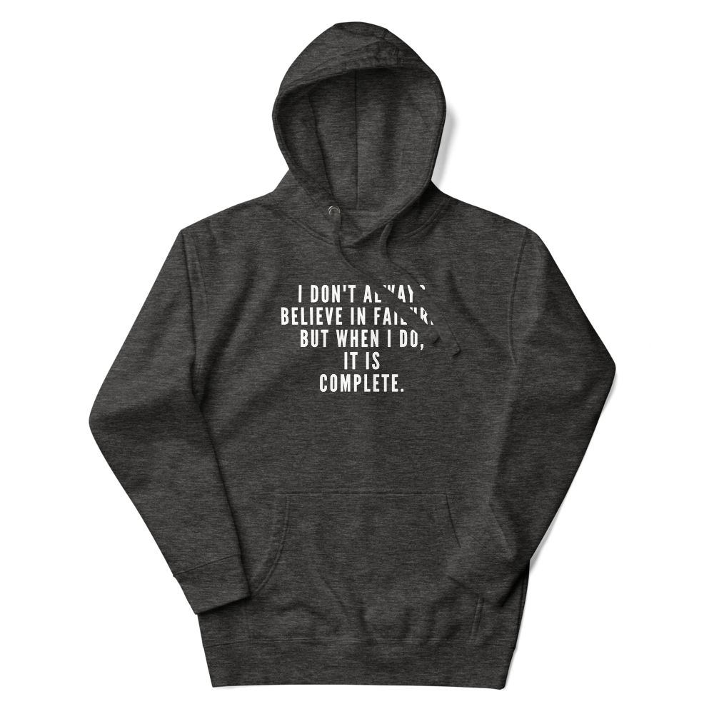 "I don't always believe in failure, but when I do, it is complete." printed on a charcoal heather unisex hoodie laying on a flat surface with the hood up