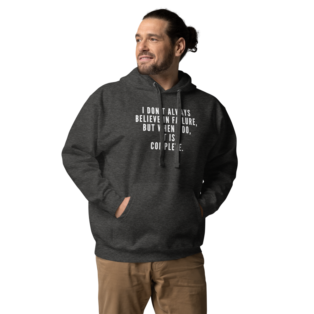 "I don't always believe in failure, but when I do, it is complete." printed on a charcoal heather unisex hoodie worn by a male