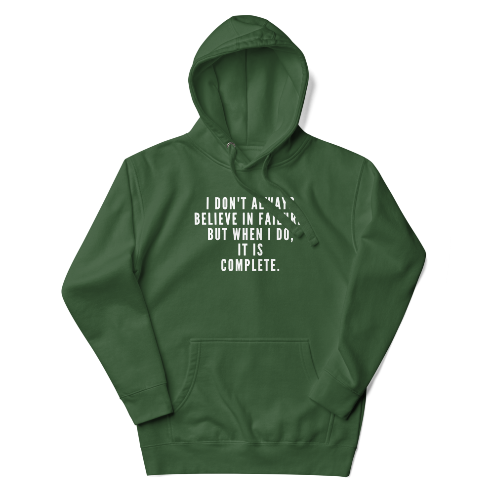 "I don't always believe in failure, but when I do, it is complete." printed on a forest green unisex hoodie laying on a flat surface with the hood up