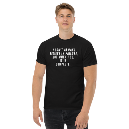 "I don't always believe in failure, but when I do, it is complete." printed on a black unisex classic tee worn by a male