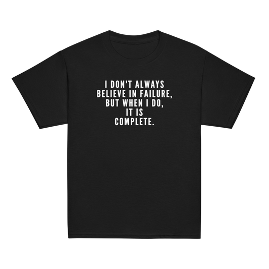 "I don't always believe in failure, but when I do, it is complete." printed on a black youth classic tee laying on a flat surface