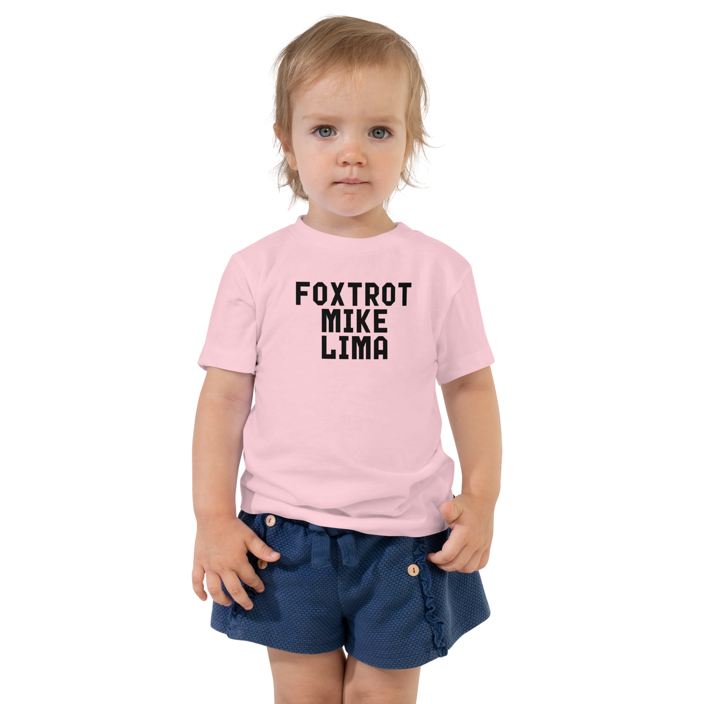 "Foxtrot Mike Lima" printed on a pink toddler short sleeve tee worn by a female
