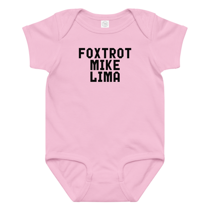 "Foxtrot Mike Lima" printed on a pink baby jersey bodysuit laying on a flat surface amongst other clothes
