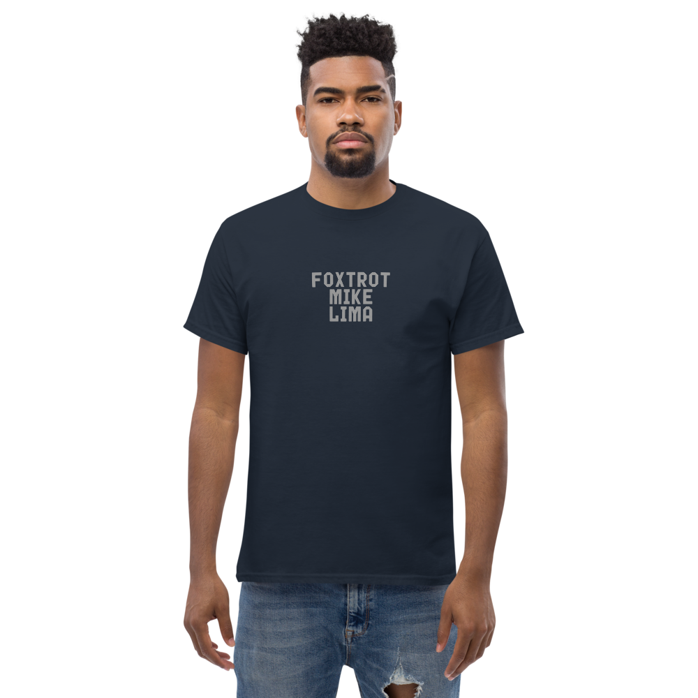 "Foxtrot Mike Lima" printed on a navy unisex classic tee worn by a male