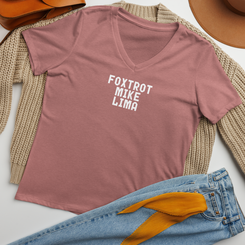 "Foxtrot Mike Lima" printed on a heather mauve women's relaxed v-neck t-shirt laying on a flat surface amongst other clothes