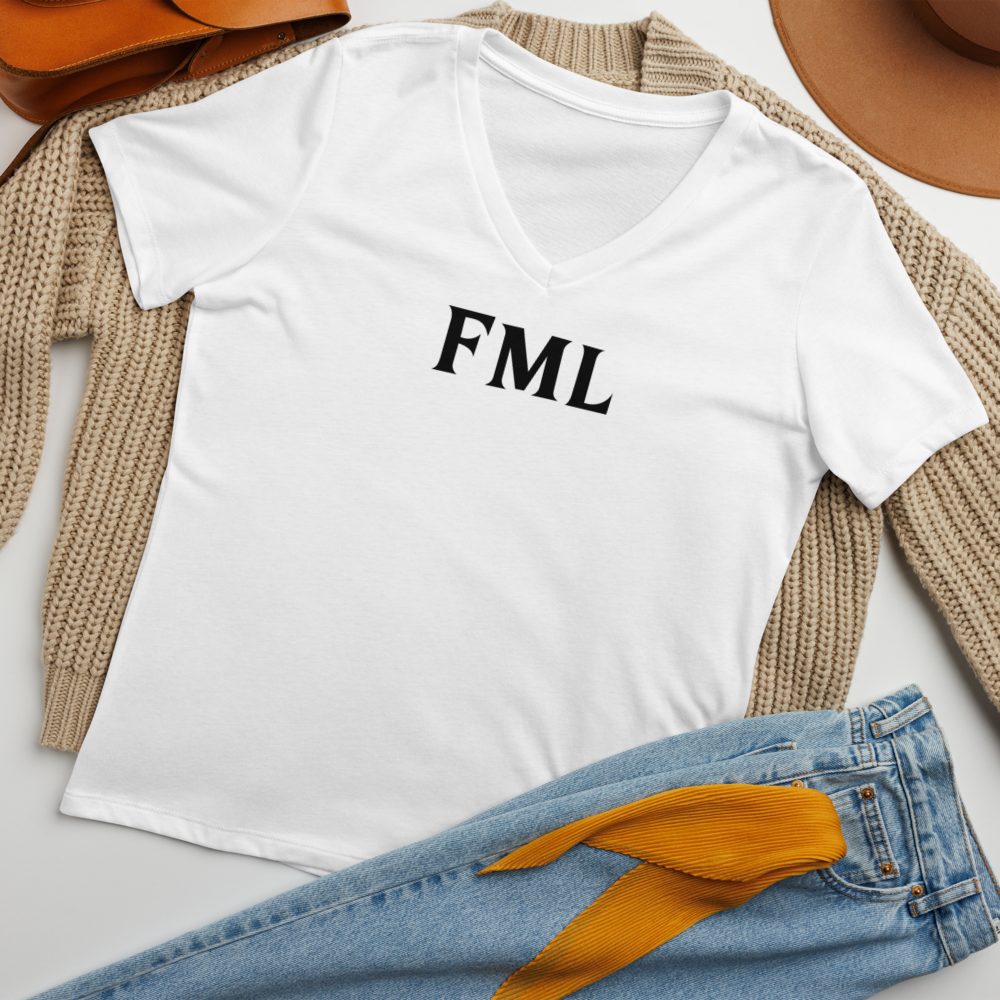 "FML" printed on a solid white blend women's relaxed v-neck t-shirt laying on a flat surface amongst other clothes