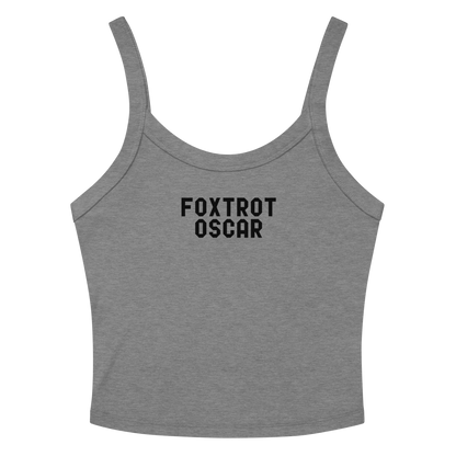 "Foxtrot Oscar" printed on a athletic heather women's micro-rib tanktop laying on a flat surface amongst sunglasses and shorts