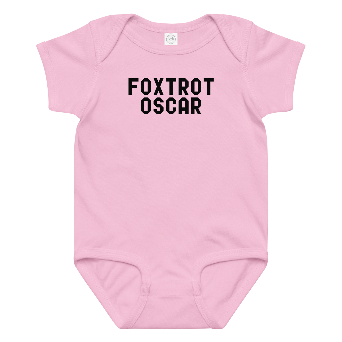 "Foxtrot Oscar" printed on a pink baby jersey bodysuit laying on a flat surface amongst other clothes
