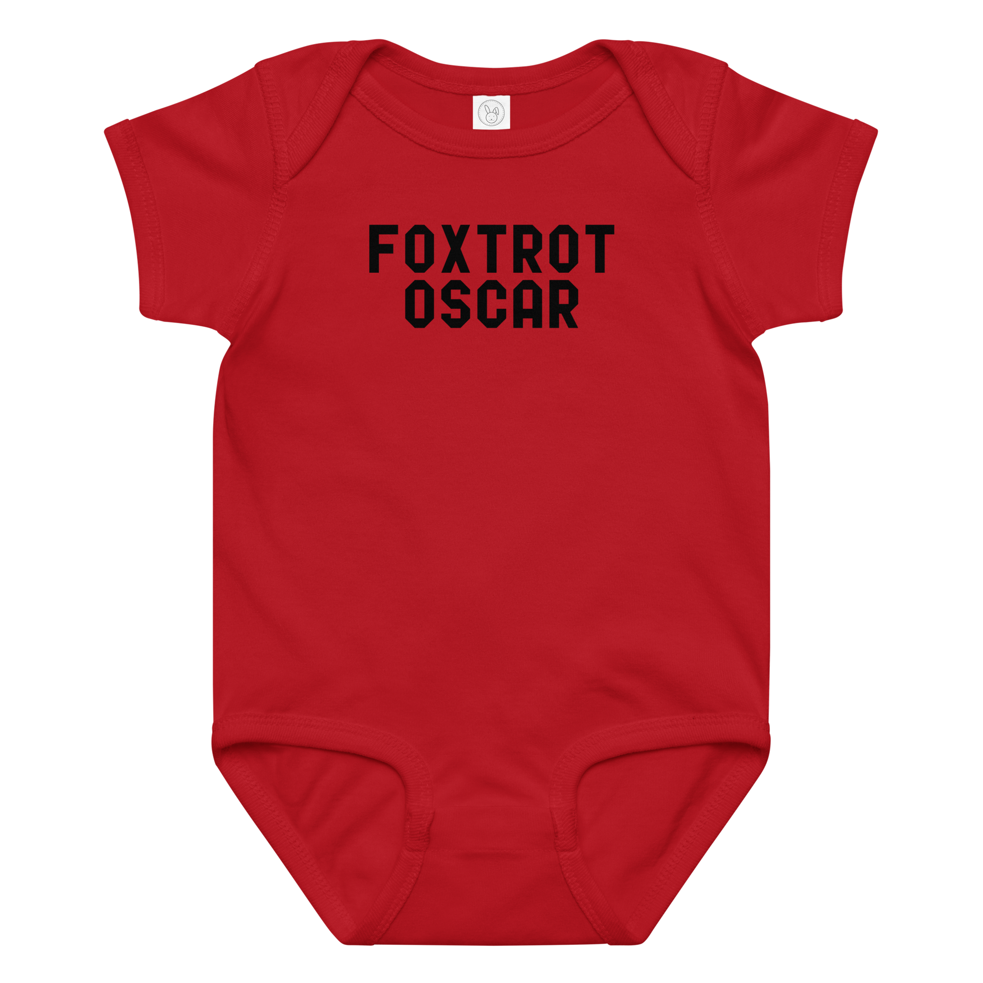 "Foxtrot Oscar" printed on a red baby jersey bodysuit laying on a flat surface amongst other clothes