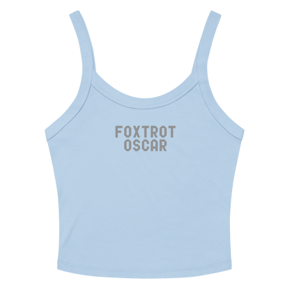 "Foxtrot Oscar" printed on a solid baby blue blend women's micro-rib tanktop laying on a flat surface amongst sunglasses and shorts