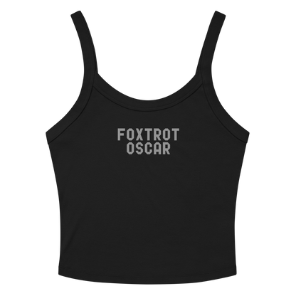 "Foxtrot Oscar" printed on a solid black blend women's micro-rib tanktop laying on a flat surface amongst sunglasses and shorts