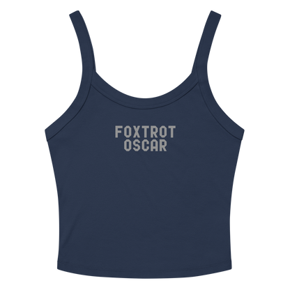 "Foxtrot Oscar" printed on a solid navy blend women's micro-rib tanktop laying on a flat surface amongst sunglasses and shorts