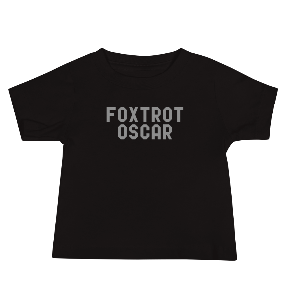 "Foxtrot Oscar" printed on a black baby jersey short sleeve tee laying on a flat surface