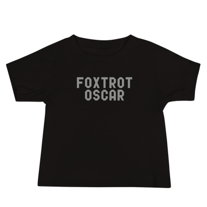 "Foxtrot Oscar" printed on a black baby jersey short sleeve tee laying on a flat surface