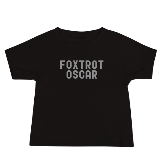 "Foxtrot Oscar" printed on a black baby jersey short sleeve tee laying on a flat surface