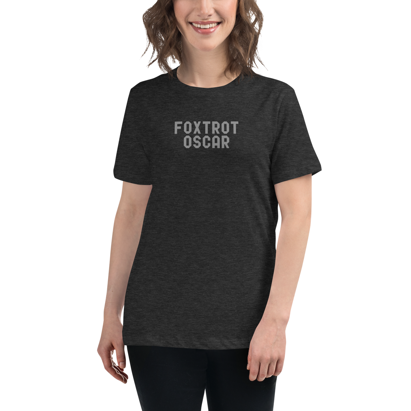 "Foxtrot Oscar" printed on a dark grey heather women's relaxed t-shirt worn by a female