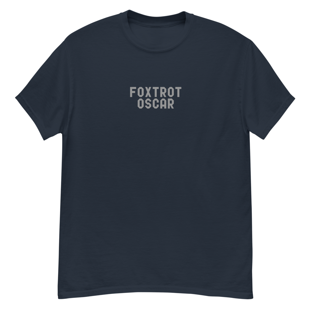 "Foxtrot Oscar" printed on a navy unisex classic tee laying on a flat surface