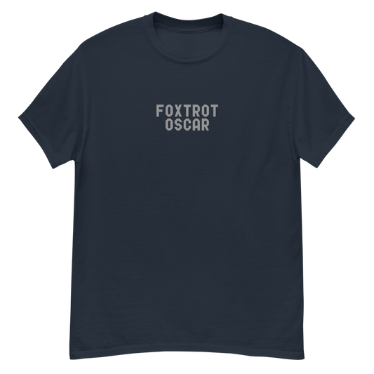 "Foxtrot Oscar" printed on a navy unisex classic tee laying on a flat surface