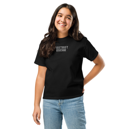 "Foxtrot Oscar" printed on a black youth classic tee worn by a female